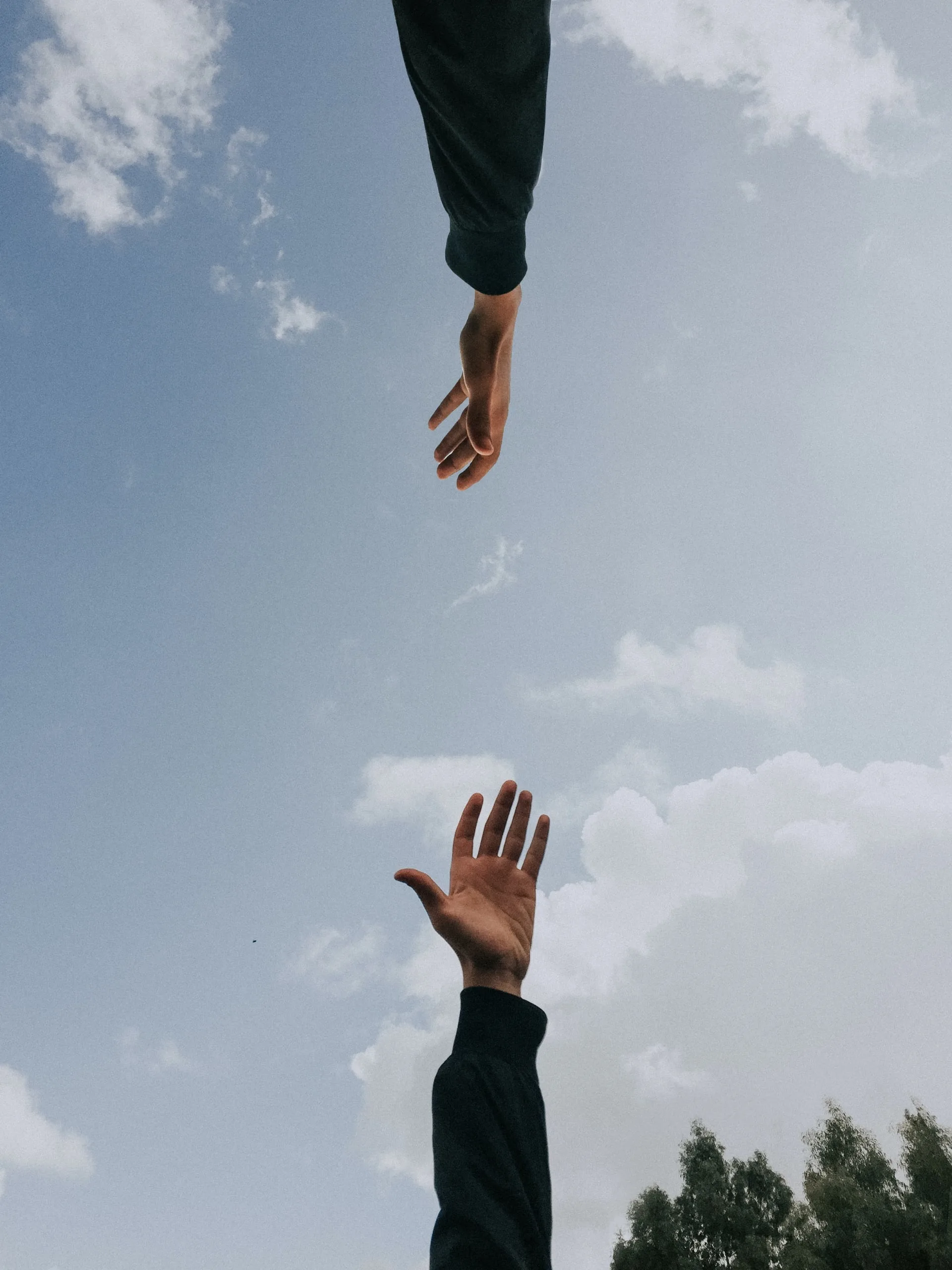 hands trying to touch each other in the sky